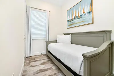 a bedroom with a bed and a painting on the wall at Oasis Cottage Near Disney With Margaritaville Resort & Island H20 Waterpark Access - 2936Sr in Orlando