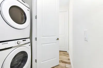 a washer and dryer in a white room at Cozy Villa Near Disney With Margaritaville Resort And Island H20 Waterpark Access - 2907Cl in Orlando