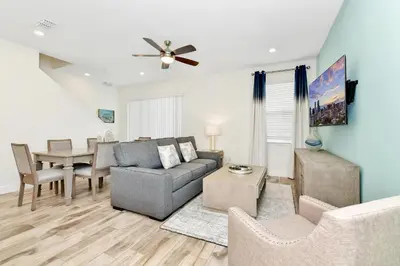 a living room with a couch and a table at Cozy Villa Near Disney With Margaritaville Resort And Island H20 Waterpark Access - 2907Cl in Orlando