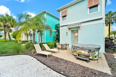 a patio with a grill in front of a house at Tequila Sunrise Cottage With Private Hot Tub Near Disney With Margaritaville Resort & Island H2O Access - 8008Dr in Orlando