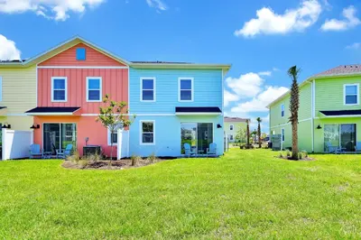 a row of colorful houses in a yard at Ocean Blue Villa Near Disney With Margaritaville Resort & Island H20 Waterpark Access - 3101Cs in Orlando
