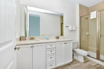 a white bathroom with a sink and a toilet at Relaxed Villa Near Disney With Margaritaville Resort & Island H20 Waterpark Access - 3169Cs in Orlando