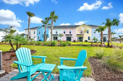 two blue chairs sitting in front of a house at Cozy Villa Near Disney With Margaritaville Resort & Island H20 Waterpark Access - 2976Or in Orlando