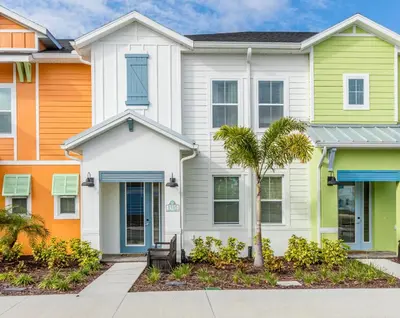 a white house with colorful houses at Comfy And Delightful Villa Near Disney With Margaritaville Resort & Island H20 Access - 8185Su in Orlando
