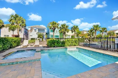 a swimming pool in a villa with palm trees at Cozy Cottage With Private Pool Near Disney With Margaritaville Resort & Island H2O Access - 8028Kd in Orlando