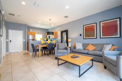 a living room with a couch and a table at Cozy 2Bd Spa & Jacuzzi Close to Disney at Encantada 3029 in Kissimmee