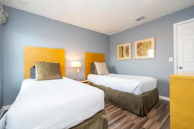 two beds in a room with blue walls at Cozy 2Bd Spa & Jacuzzi Close to Disney at Encantada 3029 in Kissimmee