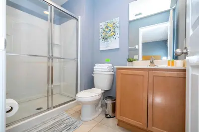 a bathroom with a shower and a toilet and a sink at Cozy 2Bd Spa & Jacuzzi Close to Disney at Encantada 3029 in Kissimmee
