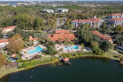 an aerial view of a mansion with a lake at Cozy 2Bd Spa & Jacuzzi Close to Disney at Encantada 3029 in Kissimmee