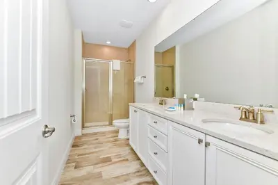 a white bathroom with a sink and a toilet at Bright Blue Villa Near Disney With Margaritaville Resort & Island H20 Waterpark Access - 3085Cs in Orlando