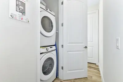 a laundry room with a washer and dryer at Blissful Villa Near Disney With Margaritaville Resort & Island H20 Waterpark Access - 3109Cs in Orlando