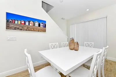 a white dining room with a white table and chairs at Tropical Villa Near Disney With Margaritaville Resort & Island H20 Waterpark Access - 3180Cs in Orlando