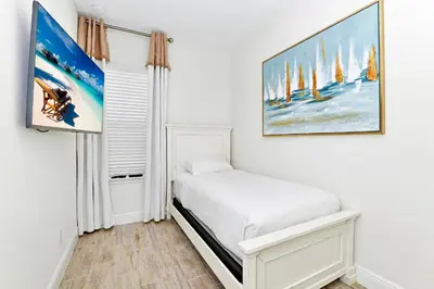 a bedroom with a bed and a painting on the wall at Tropical Villa Near Disney With Margaritaville Resort & Island H20 Waterpark Access - 3180Cs in Orlando