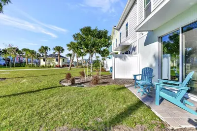 a blue bench sitting on a patio next to a house at Pleasant Villa Near Disney With Margaritaville Resort & Island H20 Access - 2916Or in Orlando