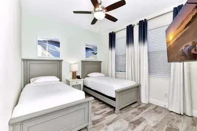 a bedroom with two beds and a ceiling fan at Pleasant Villa Near Disney With Margaritaville Resort & Island H20 Access - 2916Or in Orlando