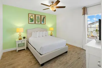 a bedroom with a bed and a ceiling fan at Beautiful Villa Near Disney With Margaritaville Resort & Island H20 Waterpark Access - 2917Cs in Orlando