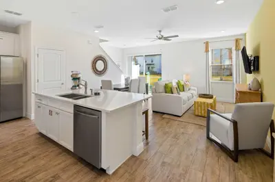 a kitchen and living room with a sink and a counter at Beautiful Villa Near Disney With Margaritaville Resort & Island H20 Waterpark Access - 2917Cs in Orlando