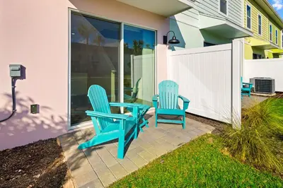 two blue chairs and a table on a patio at Beautiful Villa Near Disney With Margaritaville Resort & Island H20 Waterpark Access - 2917Cs in Orlando