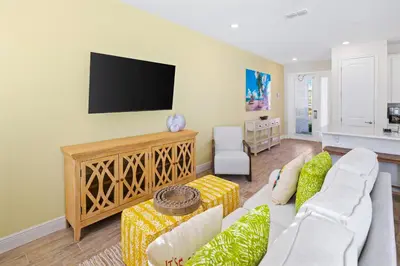 a living room with a couch and a flat screen tv at Beautiful Villa Near Disney With Margaritaville Resort & Island H20 Waterpark Access - 2917Cs in Orlando