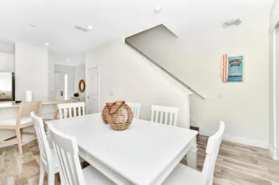 a white dining room with a white table and chairs at Spacious Villa Near Disney With Margaritaville Resort & Island H20 Waterpark Access - 2938Cl in Orlando
