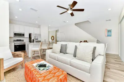 a living room with a white couch and a ceiling fan at Spacious Villa Near Disney With Margaritaville Resort & Island H20 Waterpark Access - 2938Cl in Orlando