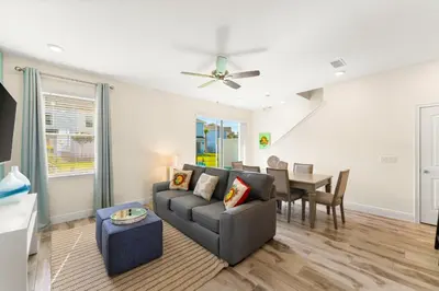 a living room with a couch and a table at Relaxing Paradise Villa Near Disney With Margaritaville Resort & Island H20 Waterpark Access - 2951Cl in Orlando