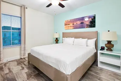 a bedroom with a large bed and a window at Dreamy Blue Villa Near Disney With Margaritaville Resort & Island H20 Waterpark Access - 2961Cs in Orlando