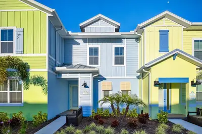 a house with yellow and blue at Dreamy Blue Villa Near Disney With Margaritaville Resort & Island H20 Waterpark Access - 2961Cs in Orlando