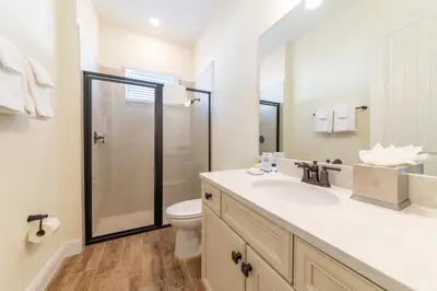 a bathroom with a toilet and a sink and a shower at Sunset Cottage Near Disney With Margaritaville Resort & Island H2O Access - 8065Ls in Orlando