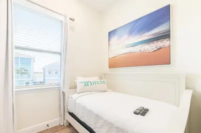 a bedroom with a bed and a window at Sunset Cottage Near Disney With Margaritaville Resort & Island H2O Access - 8065Ls in Orlando