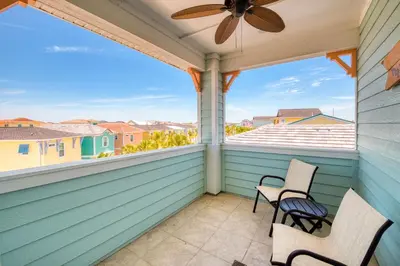 a balcony with two chairs and a ceiling fan at No Shoes Retreat! Cottage With Hot Tub Near Disney With Margaritaville Resort & Island H2O Access - 8085Dr in Orlando