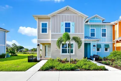 a house with a palm tree in front of it at Sunny Villa Near Disney With Margaritaville Resort & Island H20 Access - 8170Cp in Orlando