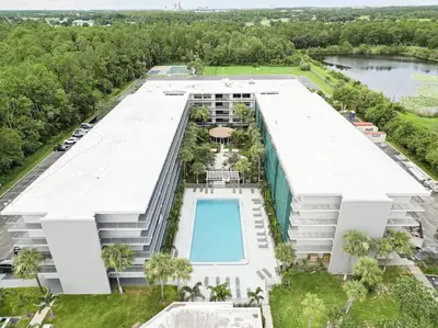 an aerial view of a building with a swimming pool at Spacious 1BR Stay Near Disney parks With pool view in Kissimmee