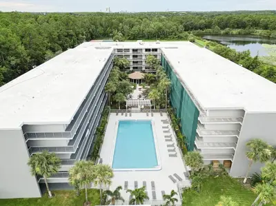 an aerial view of a building with a swimming pool at Spacious 1BR Stay Near Disney parks With pool view in Kissimmee