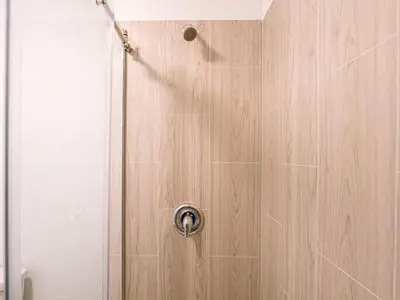 a shower with a wooden door with a shower at Fun filled 1BR Close to Disney Parks With Lake view in Vineland