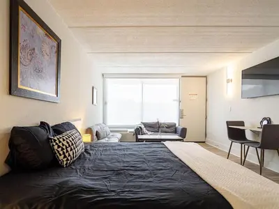 a bedroom with a large bed and a living room at Relax & Enjoy 1BR Home Near Disney Parks With Lake view in Kissimmee