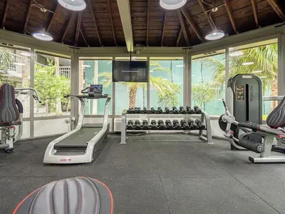 a gym with treadmills and machines in a room at Relax & Enjoy 1BR Home Near Disney Parks With Lake view in Kissimmee