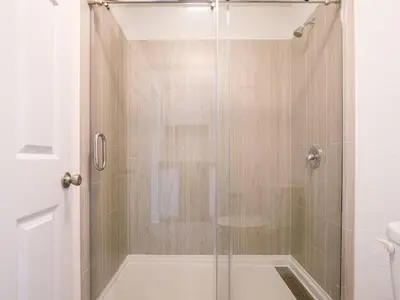 a shower with a glass door in a bathroom at Delightful 1BR Condo Next to Disney With Lake view in Vineland