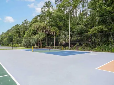a tennis court with a net on it at Delightful 1BR Condo Next to Disney With Lake view in Vineland