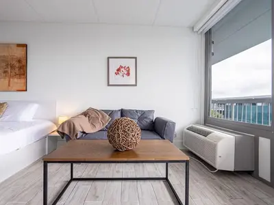 a living room with a couch and a table at Lovely 1BR Suite Minutes to Disney With Lake view in Vineland