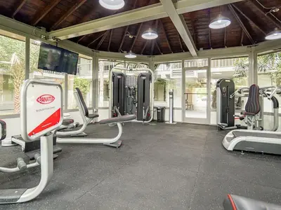 a gym with lots of cardio equipment in a building at Elegant 1BR Haven in Orlando & 5 minutes to Disney in Vineland