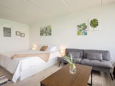 a white bedroom with a bed and a couch at Welcoming 1BR Gateway Orlando 5 minutes to Disney in Vineland