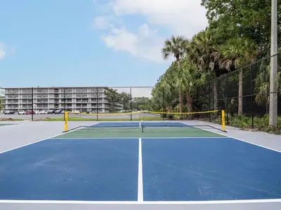 a tennis court with a net on top of it at Comfy 1BR Space in Orlando & 5 minutes to Disney in Vineland