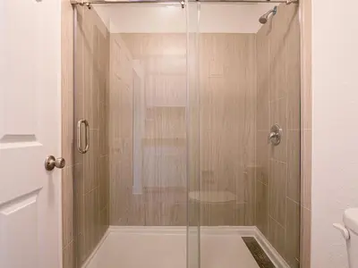 a shower with a glass door in a bathroom at Comfy 1BR Space in Orlando & 5 minutes to Disney in Vineland