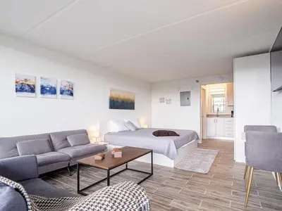 a living room with a bed and a couch at Comfy 1BR Space in Orlando & 5 minutes to Disney in Vineland