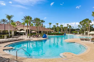 a swimming pool at a resort with palm trees at 3BR Disney Getaway, Pool, Waterslides, By Disney in Orlando