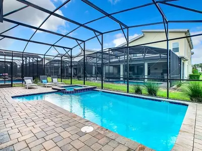 a large swimming pool with a clear cover over it at Once Upon a Villa in Kissimmee