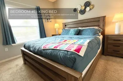 a bed with a wooden frame in a bedroom at Spacious 4-Bedroom Family Retreat Near Disneyland! in Kissimmee