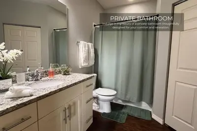 a bathroom with a sink and a toilet and a shower at Spacious 4-Bedroom Family Retreat Near Disneyland! in Kissimmee