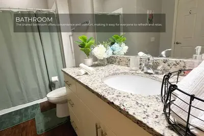 a bathroom with a sink and a toilet and a mirror at Spacious 4-Bedroom Family Retreat Near Disneyland! in Kissimmee